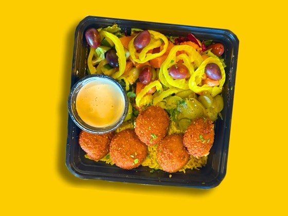 Falafel rice bowl with salad and tahini sauce