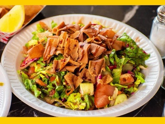 Fattoush salad with greens, tomato, cucumber and fried pita chips