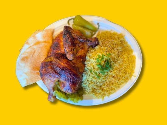 Half rotisserie chicken with rice, hummus, pickles and bread