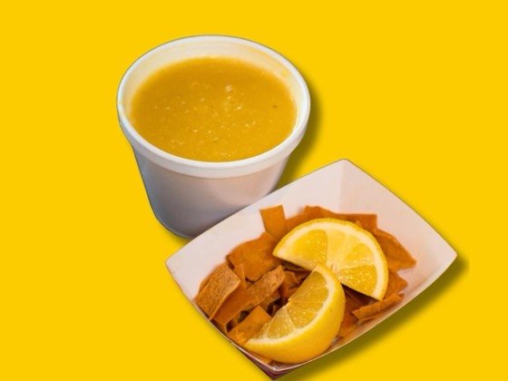 Bowl of red lentil soup with cumin and lemon