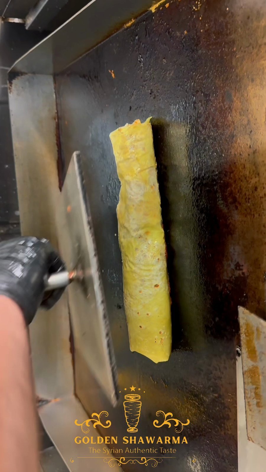 Saj flatbread cooking on the domed griddle at Golden Shawarma in Richardson